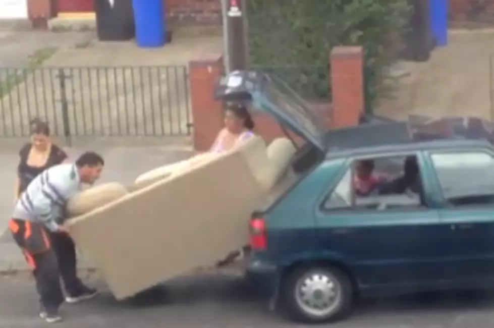 Watch & Laugh as These Folks Attempt to Stuff a Large Couch Into a Tiny Car