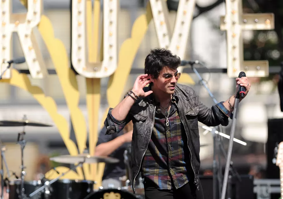 Here&#8217;s Joe Jonas Doing Something Vulgar to a Picture of Adam Levine [PHOTO]