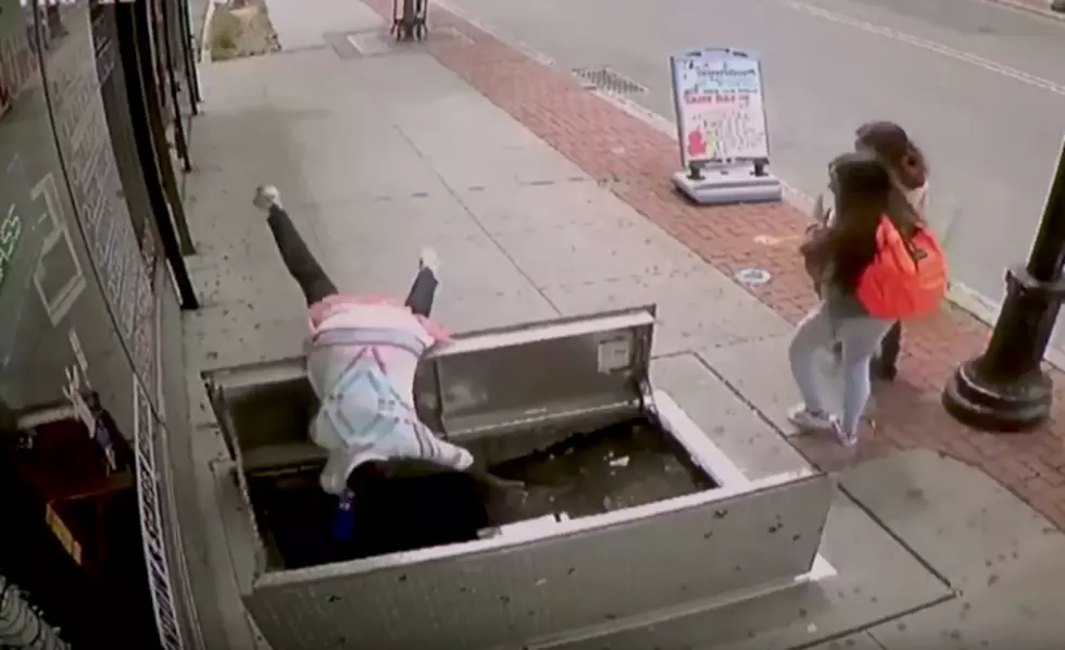 Woman Can&#8217;t Look Away From Her Phone, Falls Into Open Street Hatch [VIDEO]