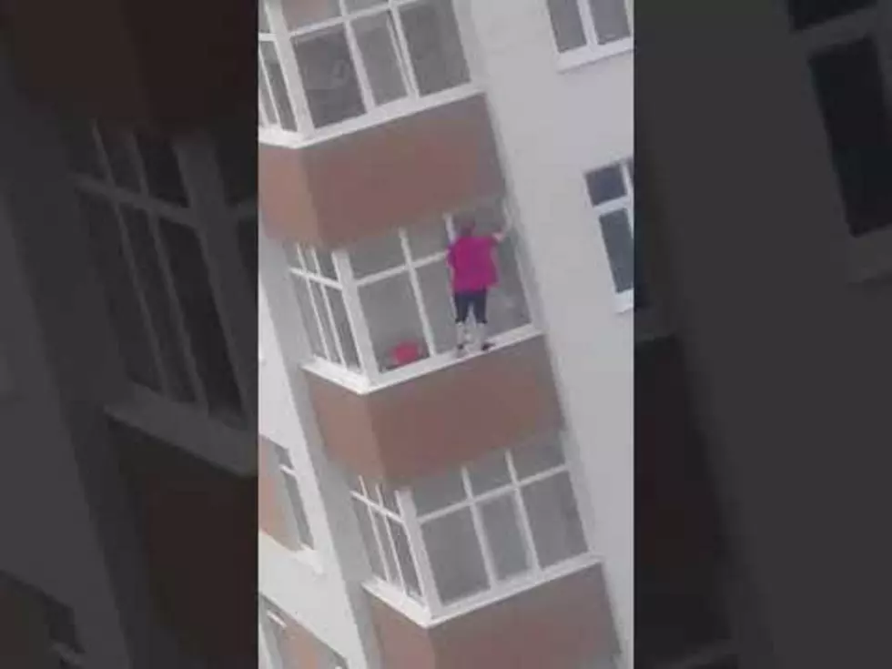 Woman Balances on 5th Floor Ledge to Clean Windows [VIDEO]
