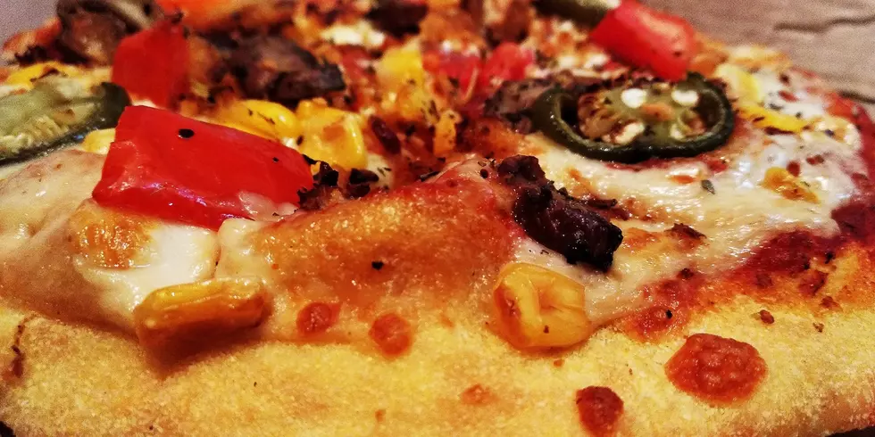 Delicious pizza with Marguerite and cheese topping and little capsicum.