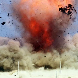 An explosion scatters debris during a live-fire demonstration