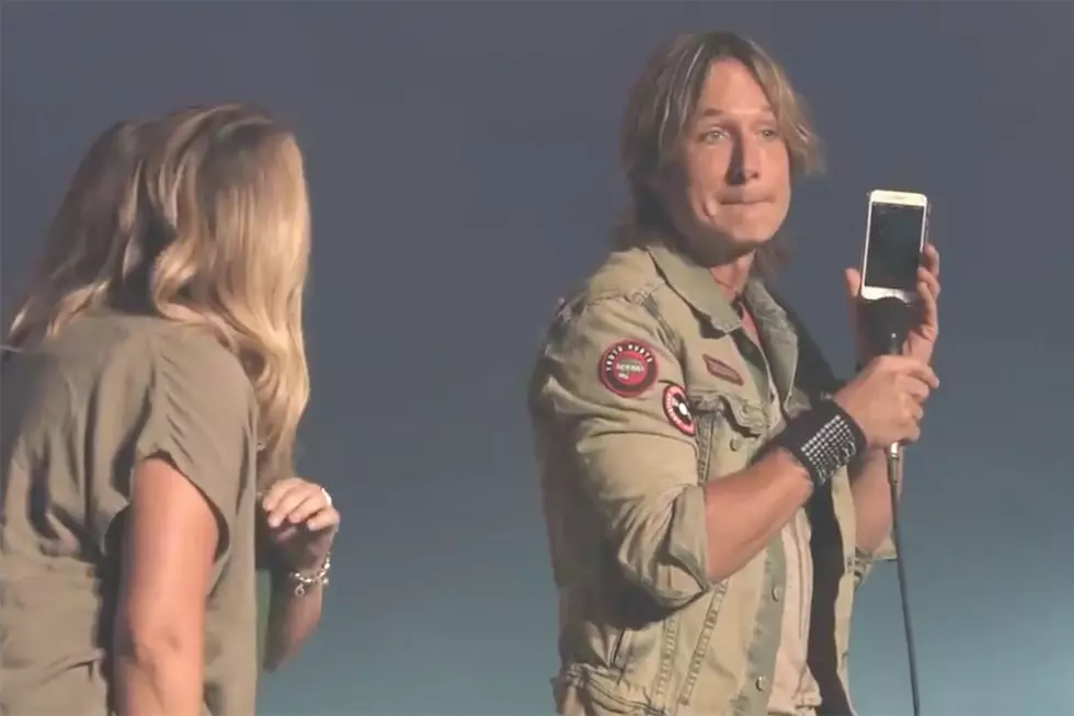 Keith Urban Helps Two Fans Win a Bet When He Calls Their Boss Live Onstage [Watch]