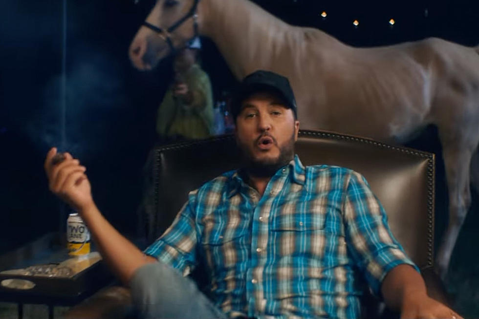 Luke Bryan Hitches a Ride to Good Times in &#8216;But I Got a Beer in My Hand&#8217; Video [Watch]