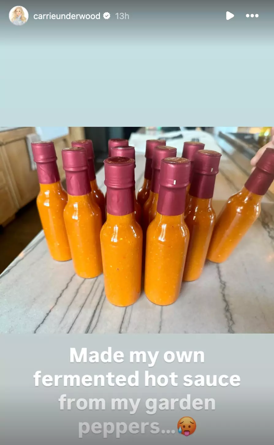 Screenshot of 12 bottles of orange hot sauce Carrie Underwood made and posted to her Instagram stories