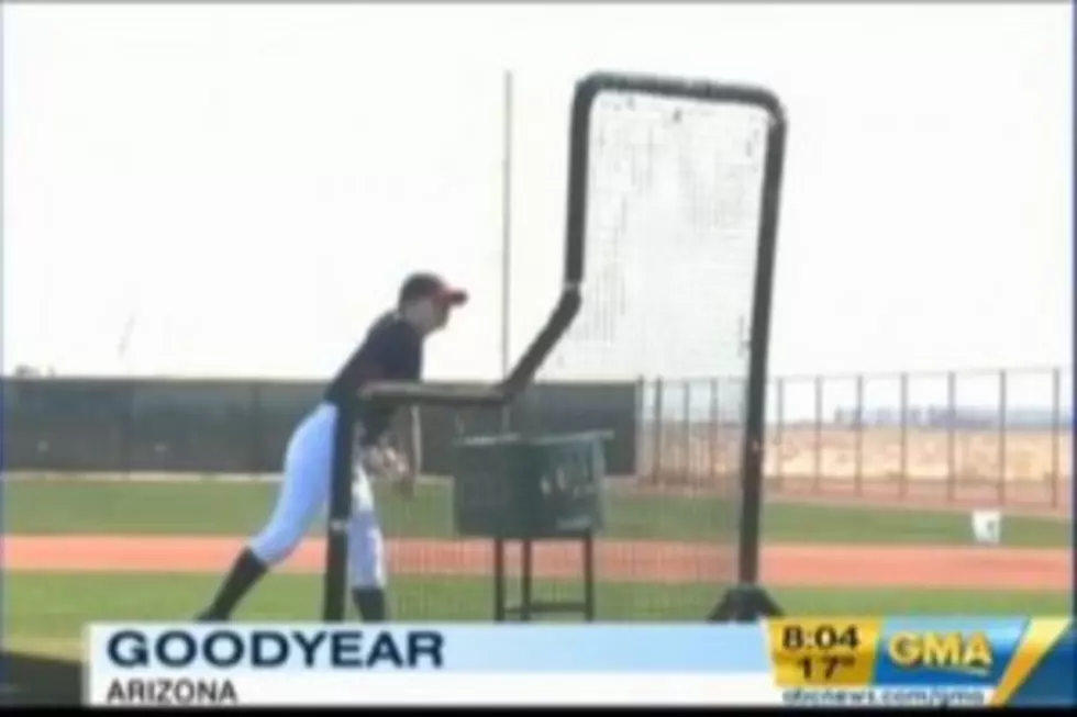 Woman Pitches at Batting Practice