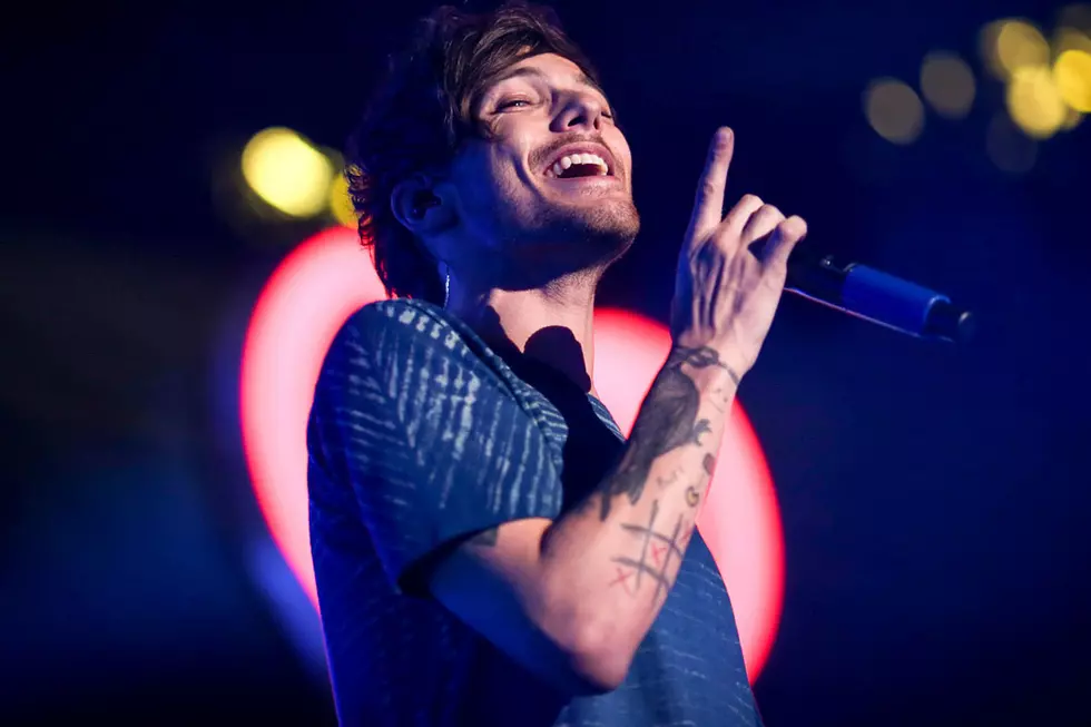 Louis Tomlinson Installs Car Seat, Fans Still Insist ‘Larry’ Is Real