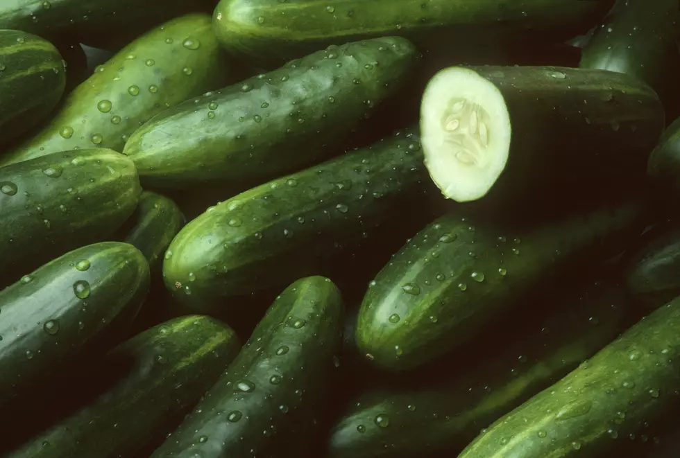 Pile of fresh cucumbers with one cut open