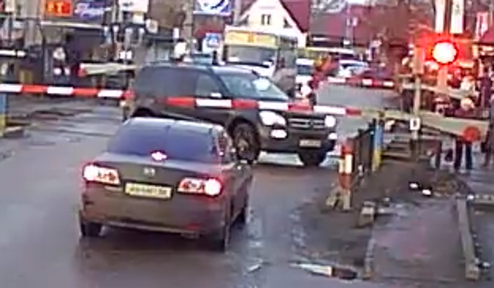 SUV Gets Caught Between Railroad Crossing Gates 