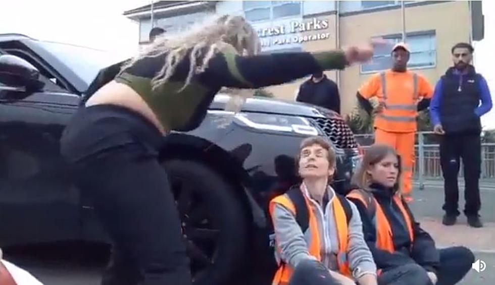 Mother Starts to Drive Over Protester Blocking a Road to School