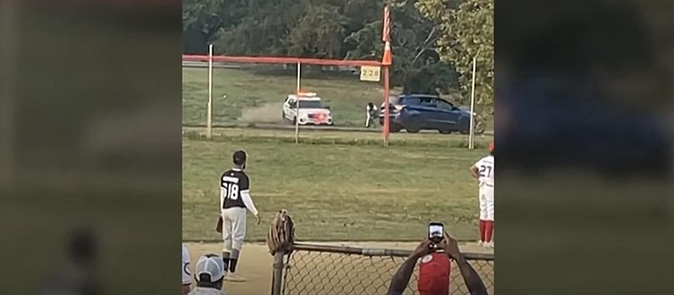 Bicyclist Evades New York Police Car at Baseball Game