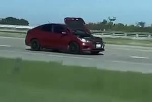 Car Seen Traveling Down Highway in Dallas With Hood Open