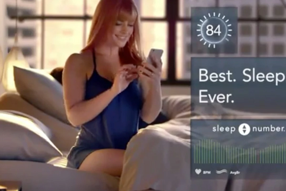 mattress commercial with couple doing crossword in bed