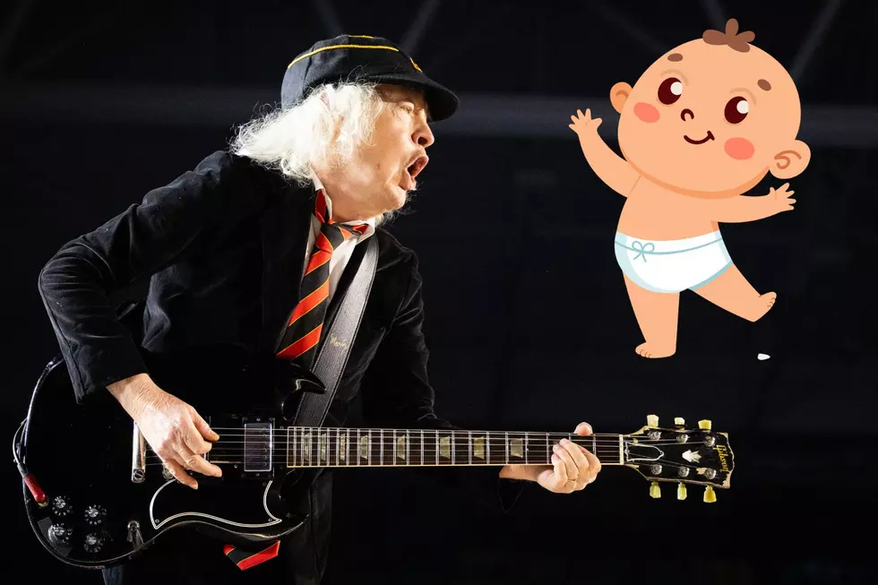 Angus Young Signs Baby at Surprise Toronto Pop Up Appearance