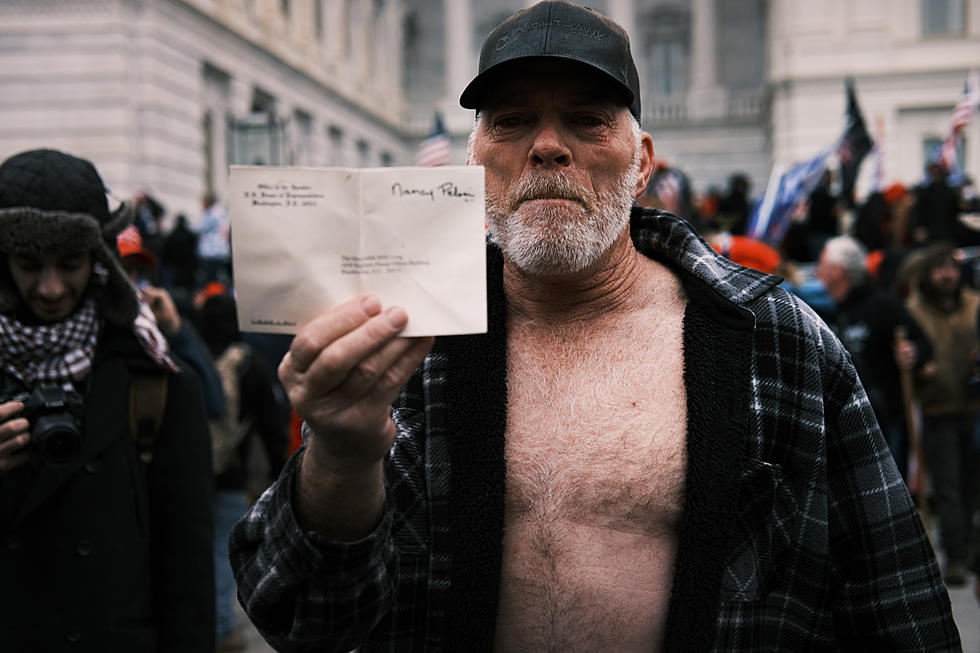 Man Who Posed For Photo at Pelosi’s Desk Selling Autographed Copies to Cover Legal Fees