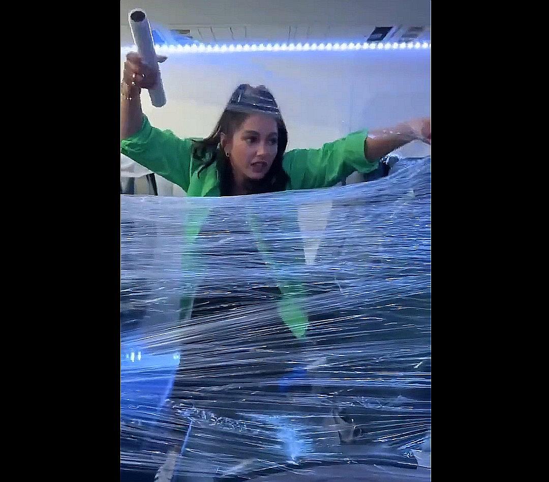 Woman Turns Row of Airplane Seats Into a Fort Using Plastic Wrap