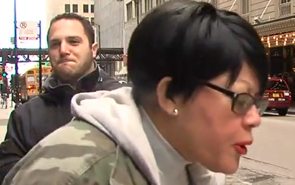 Crazy Spitting Woman Interupts A Television Reporter [VIDEO]