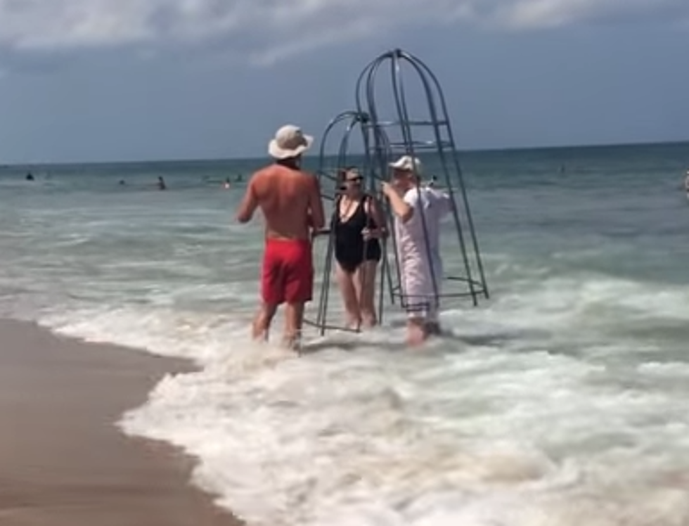 Couple Brings Homemade Shark Cages To The Beach [VIDEO]