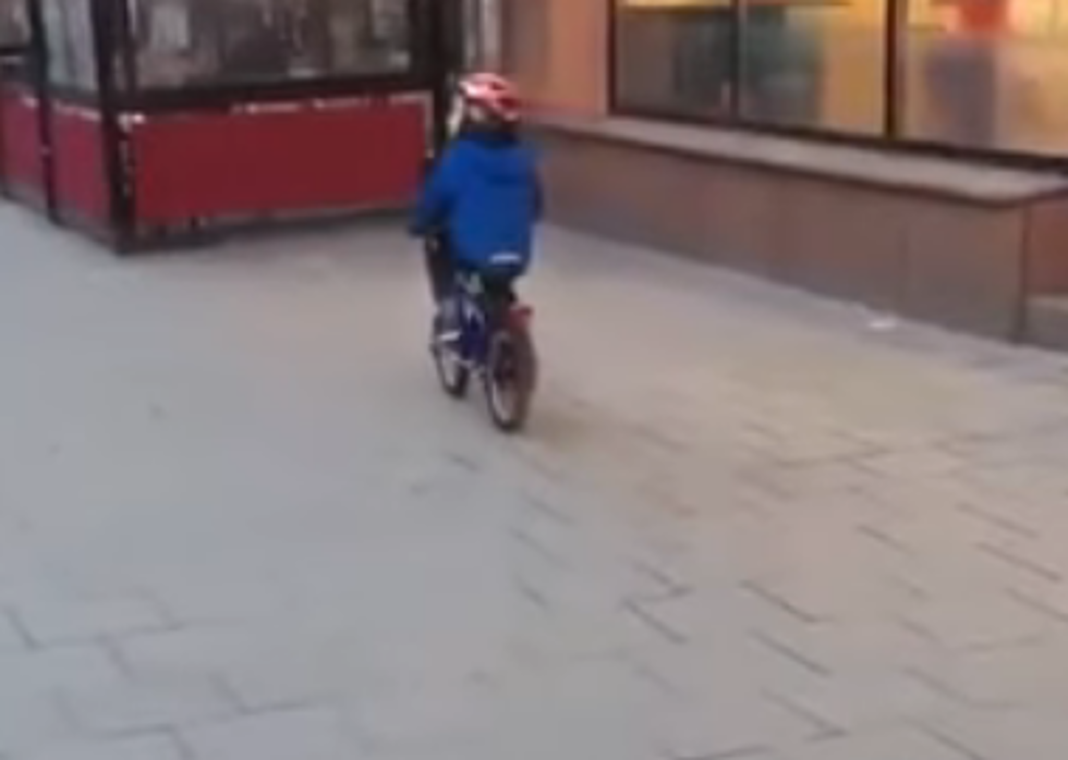 Little Kid On Bike Distracted By Strip Club Van [VIDEO]