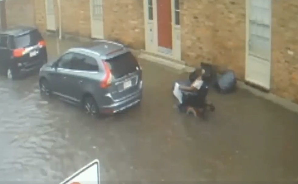 Port Of Call Workers Rescue Man Whose Wheelchair Tips Over In New Orleans Floodwaters [VIDEO]