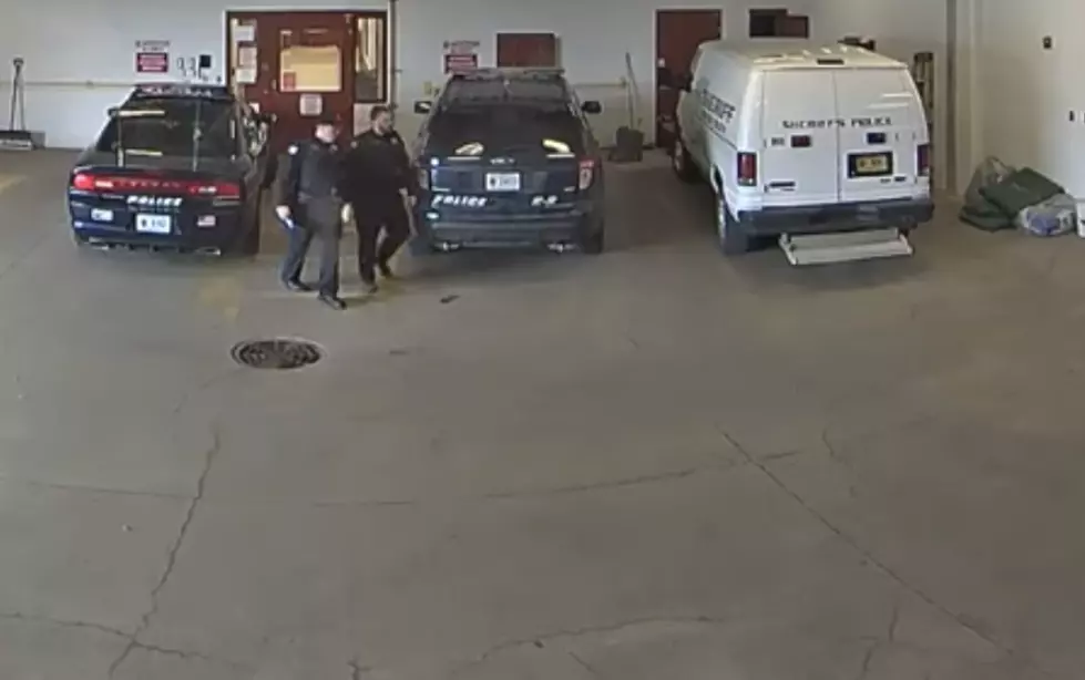 Inmate Escapes Police Custody By Running Under Garage Door [VIDEO]