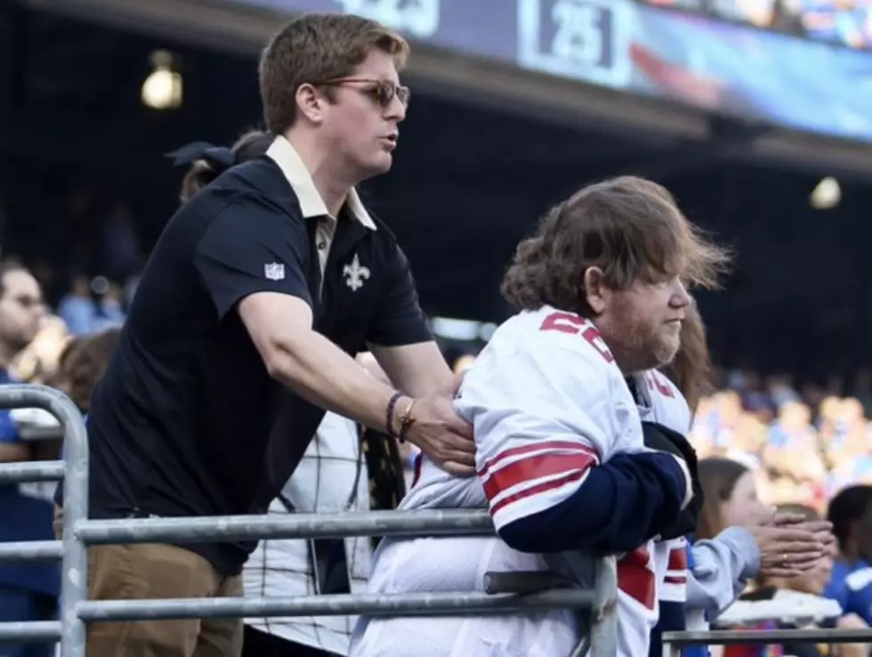 Saints Fan Assists New York Giants Fan During National Anthem [PHOTO]