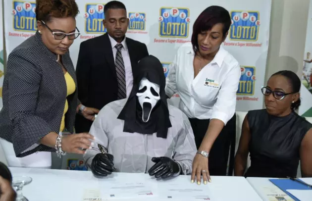 Lottery Winner Conceals Self During Collection Ceremony [PHOTOS]