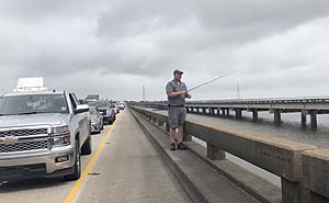 Man Fishes Off I-10 Bonnet Carré Spillway Bridge While Traffic...
