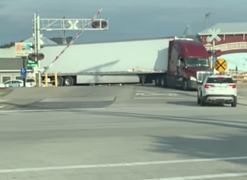 Semi Slams Into Truck That is Stopped on Railroad Tracks [VIDEO]