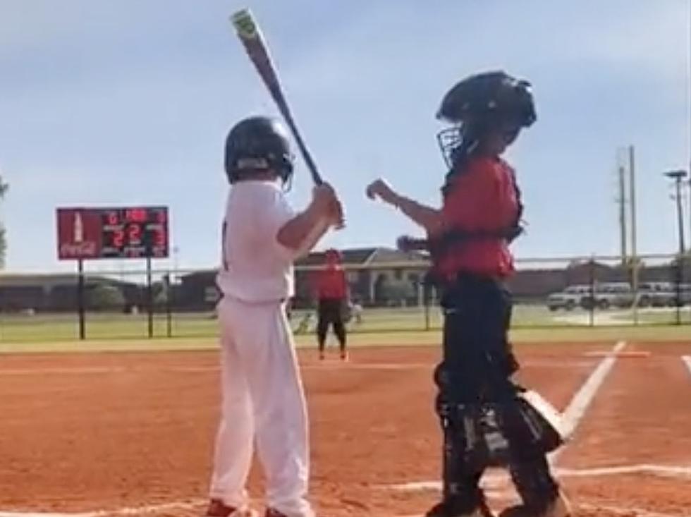 Catcher Helps Batter With Hands on Bat While at The Plate [VIDEO]