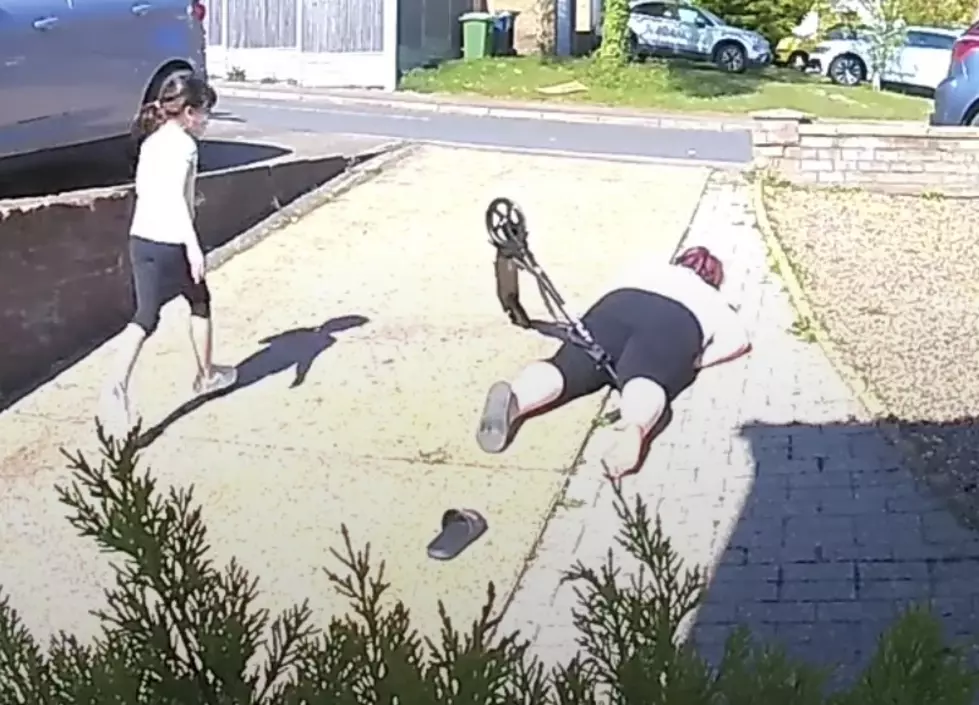 Watch a Mom Faceplant While Attempting to Ride Scooter in Driveway