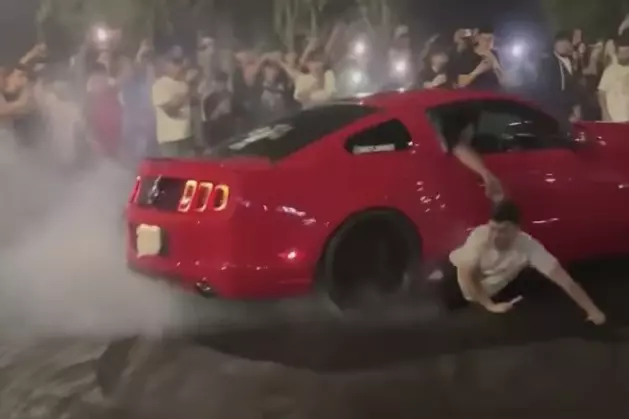 Car Runs Over Man While Doing Donuts, He Somehow Walks Away [WATCH]