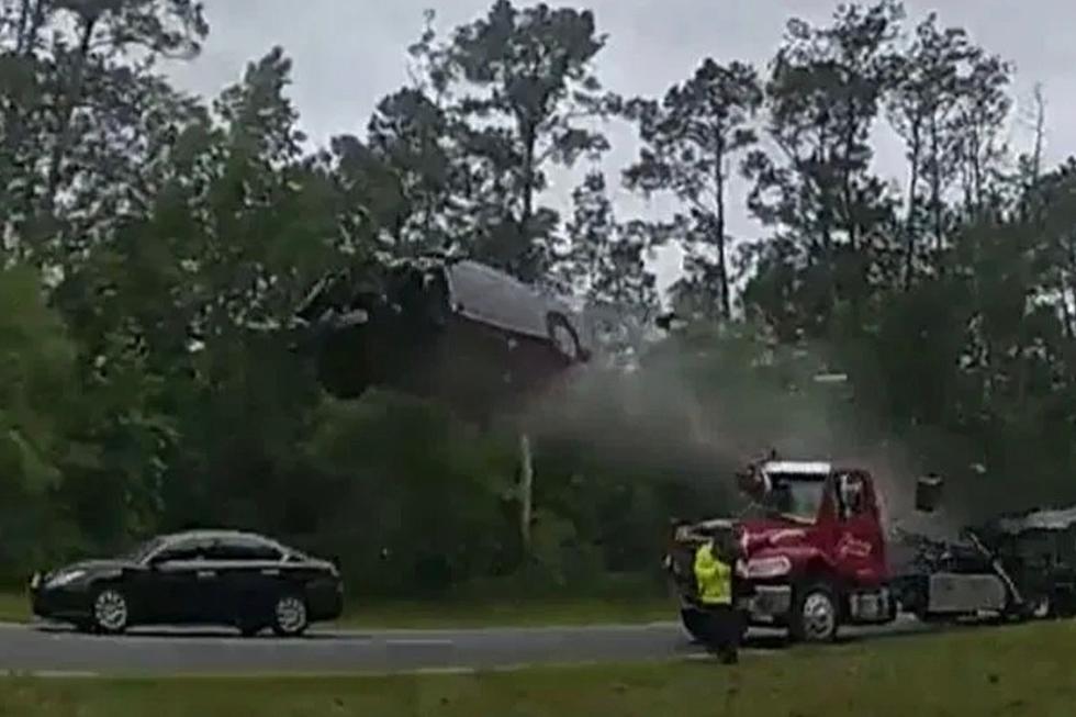 Wild Police Cam Shows Moment Car Launches Off Tow Truck Ramp, Flying Airborne Before Crashing