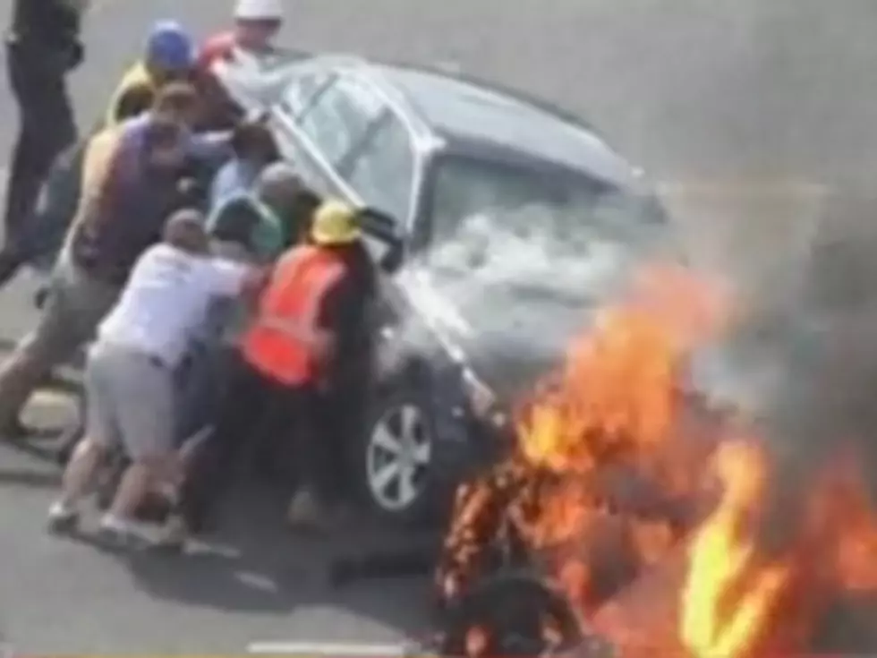 Heroic Crowd Lifts Burning Car Off Motorcyclist in Incredible Footage [VIDEO]