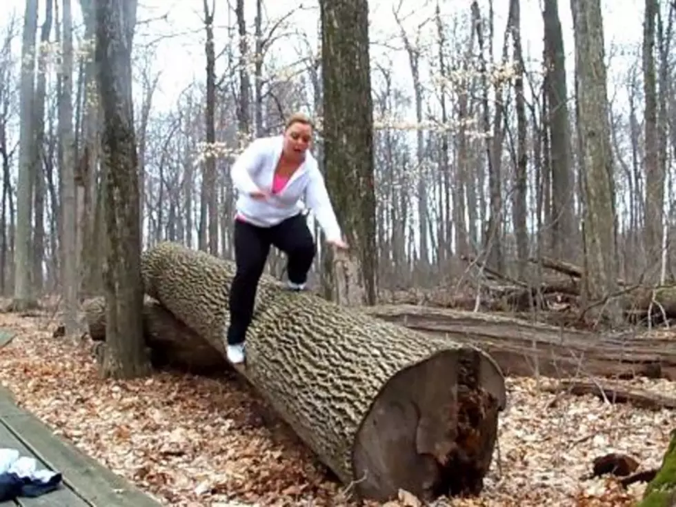 Woman Slips and Falls While Attempting to Walk Across Downed Tree Branch