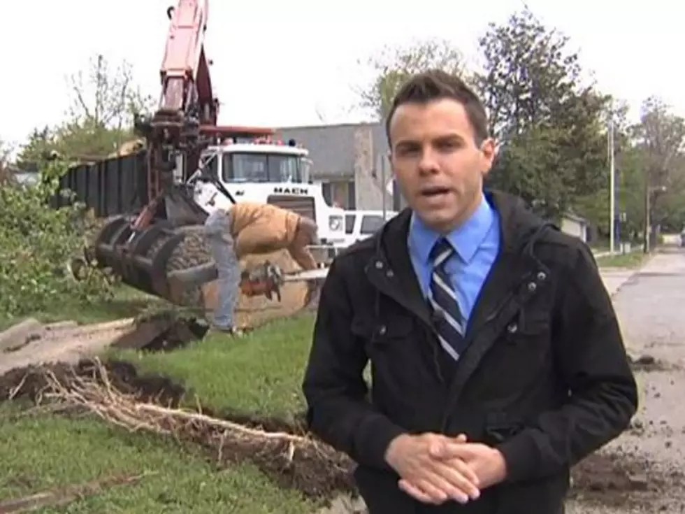 Terrible Chainsaw Mishap Almost Happens in Background of News Report [VIDEO]