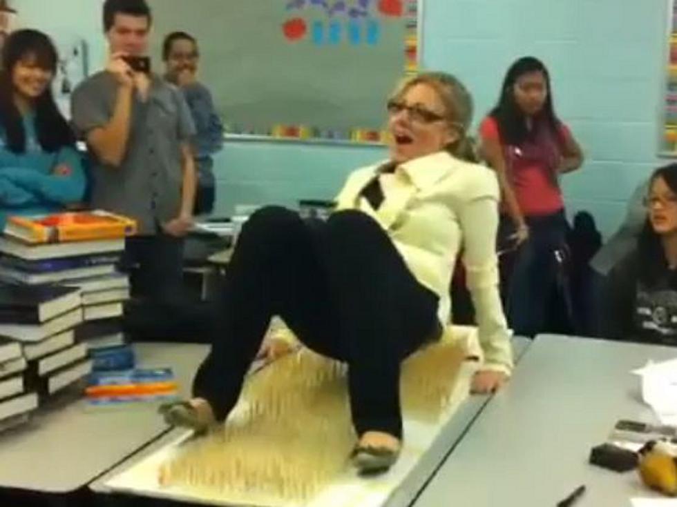 Crazy Teacher Lays Down on Bed of Toothpicks [VIDEO]