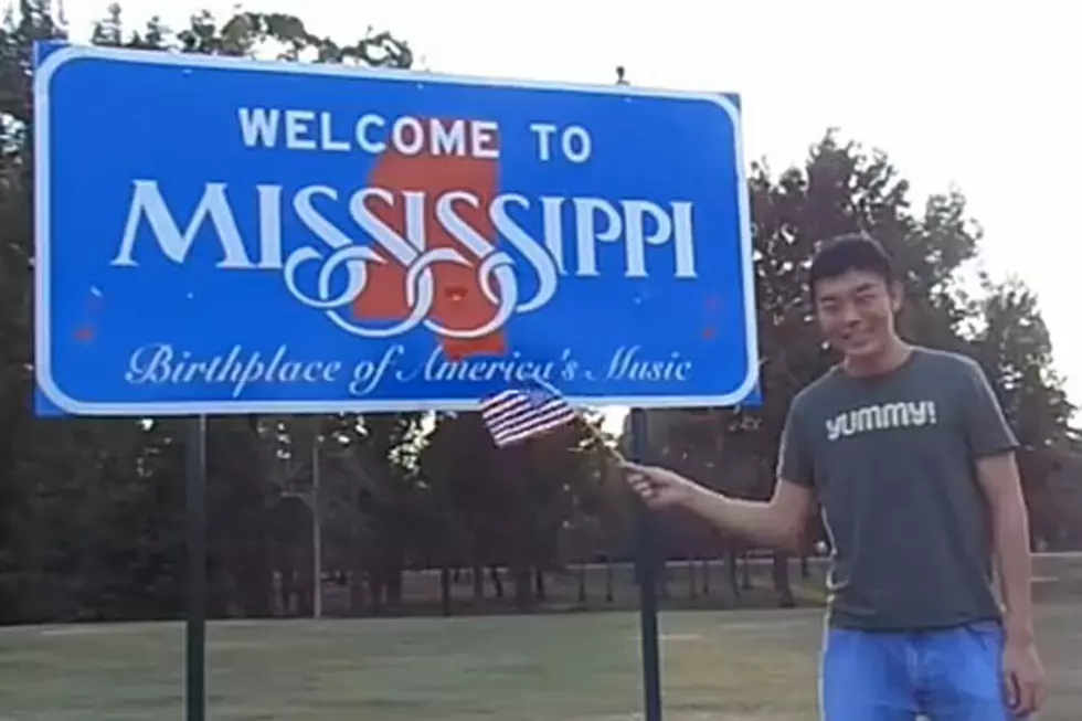 Man Waves Flag in Every State
