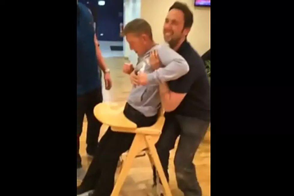 Somehow, This Grown Man Wound Up Stuck in a High Chair