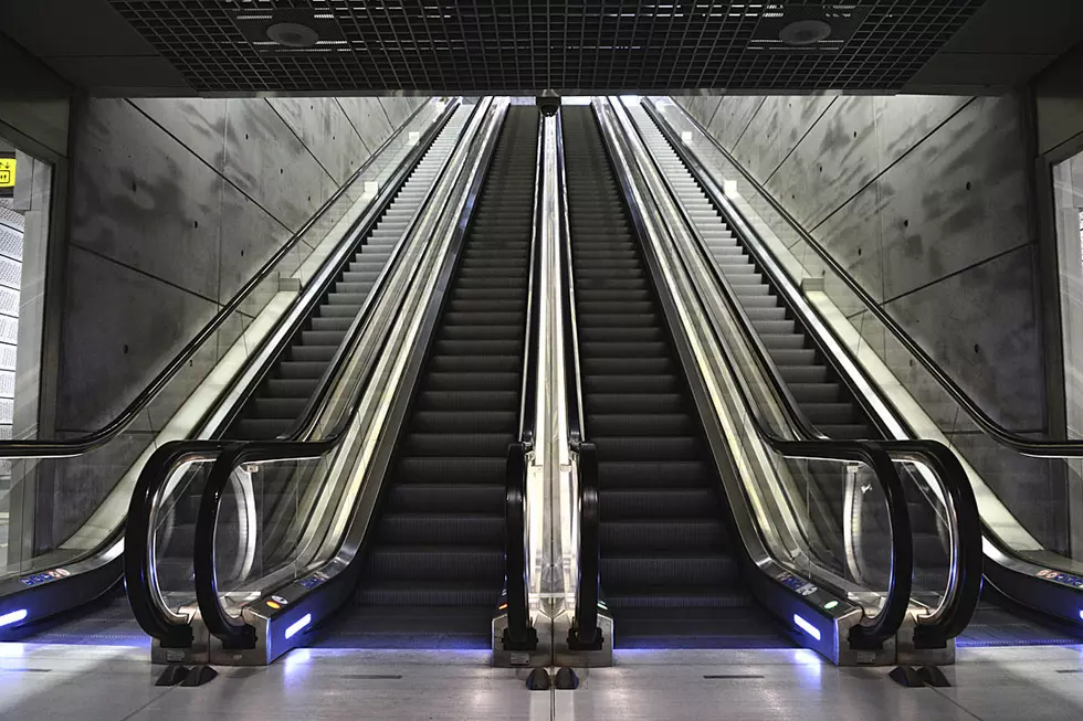 Old Woman Going Up the Down Escalator Is Moving Nowhere Slow