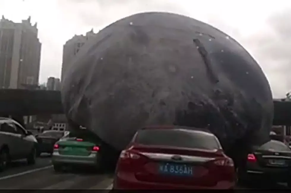 Giant Out-of-Control Inflatable Moon Rolls Wild Along Chinese Streets