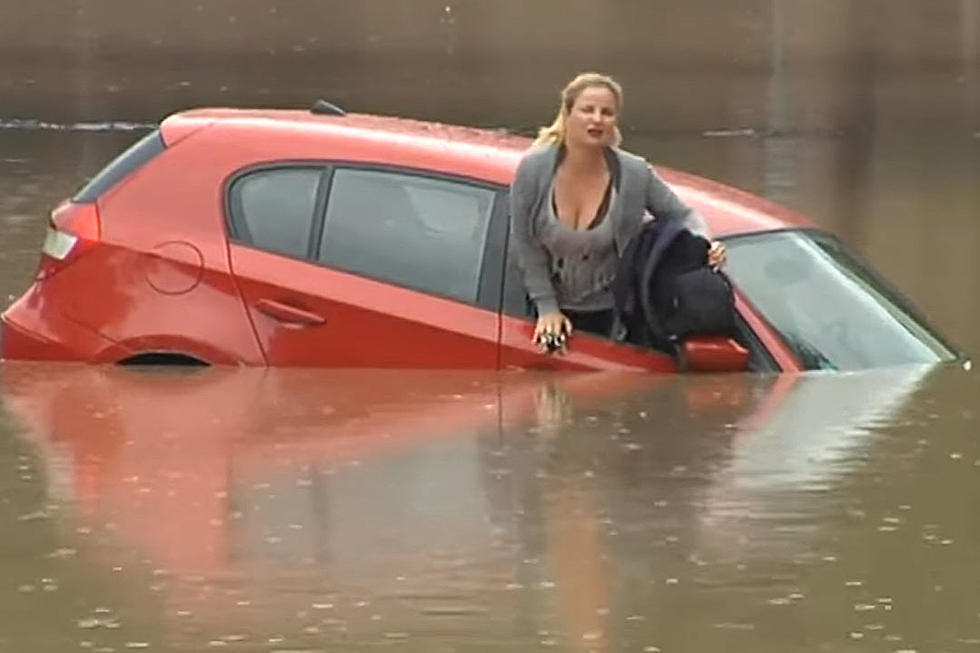 Agile Woman Deftly Escapes Onto Car Roof During Flood