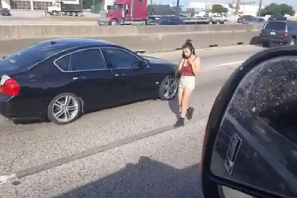 Watch Woman on Her Phone Walking in the Middle of a Highway 