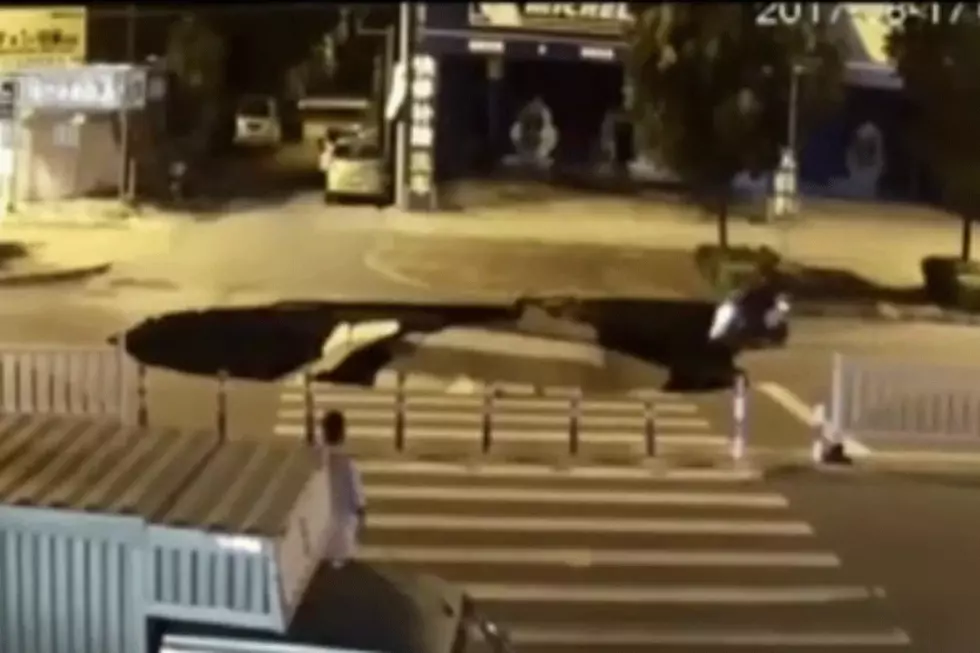 Man on Scooter Checking Phone Rides Right Into Sinkhole