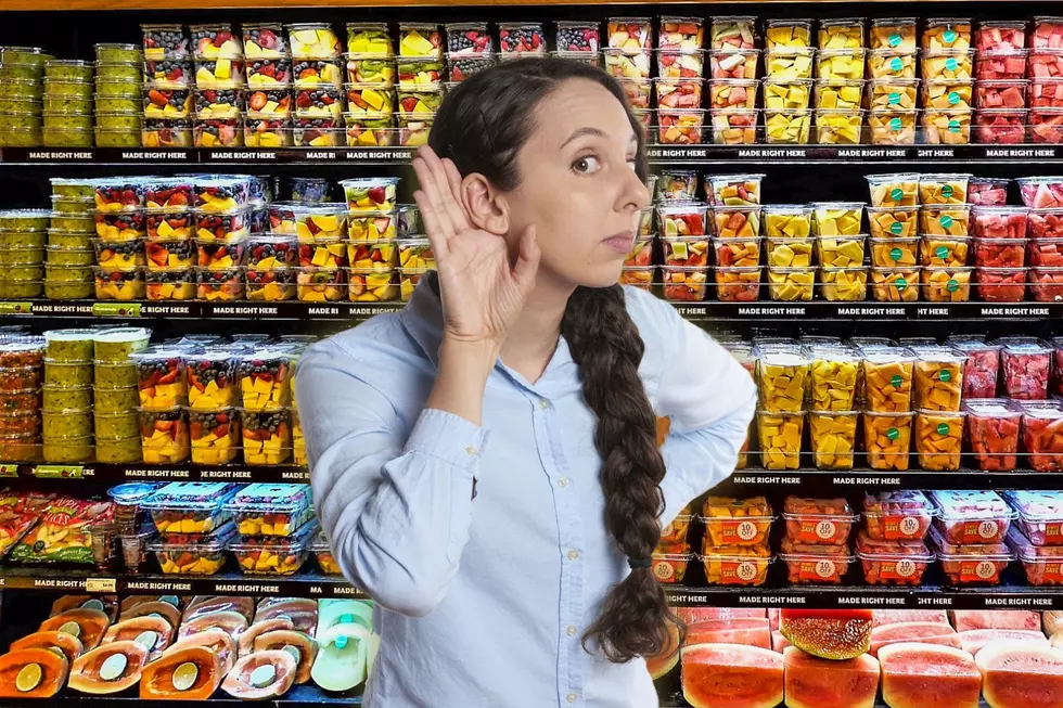 Woman listening to music while shopping for groceries