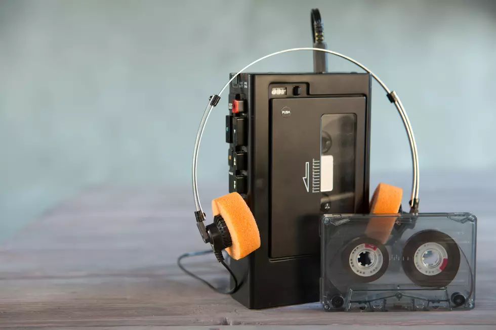 Old portable cassette player and headphones on a abstract background. Vintage advertisement style