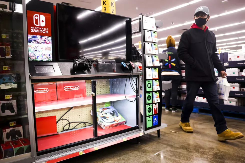 Customer walks past video games at walmart