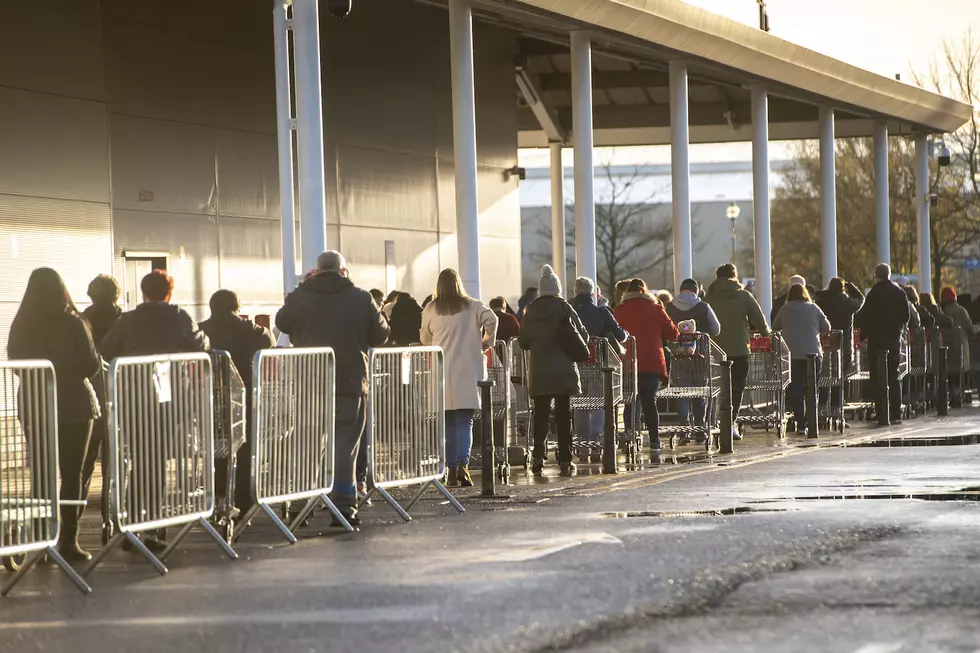 Shoppers wait in line to get inside costco