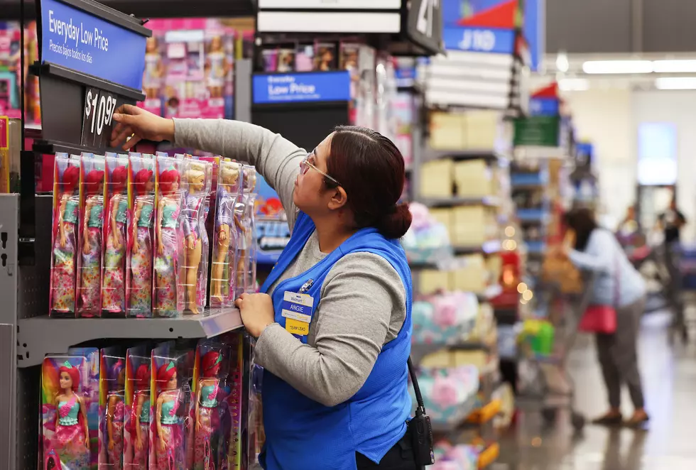 Walmart employee preparing shelves