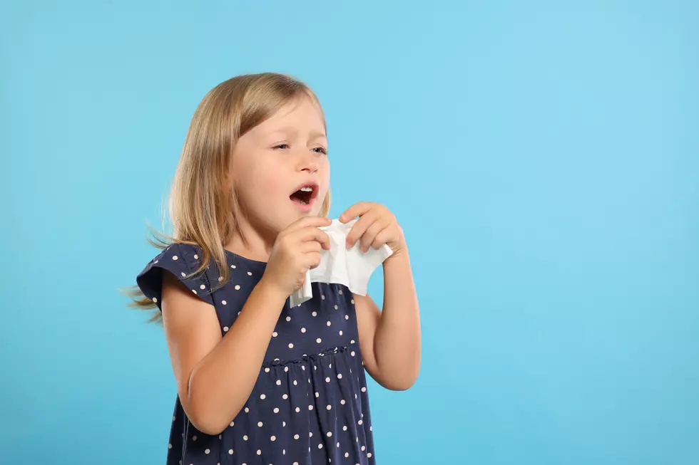 Girl with blond hair getting ready to sneeze